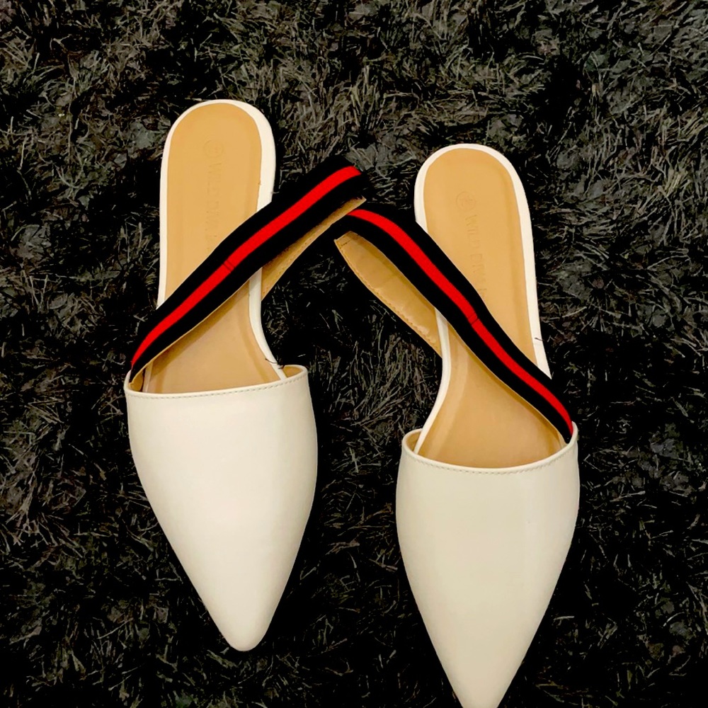 White flats with navy and red ankle strap.